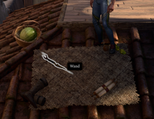 Wand as it's found among a rooftop picnic spread, alongside Green Grapes, Sunmelon, Simple Boots, and a Scroll of Charm Person.