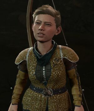 A halfling in a gold tunic and short, combed hair. She has buckteeth and a wry half-smile.