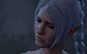 A picture of Shadowheart. She is standing by a statue of Selune in the Lower City of Baldur's Gate. Overwhelmed by feelings of grief and shame, she is in tears, with these feelings plain on her face.