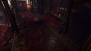 The interior of the Devil's Fee. A red carpet leads up to a counter stationed by Helsik. Devilsh and monstrous trophies and monuments adorn the room.